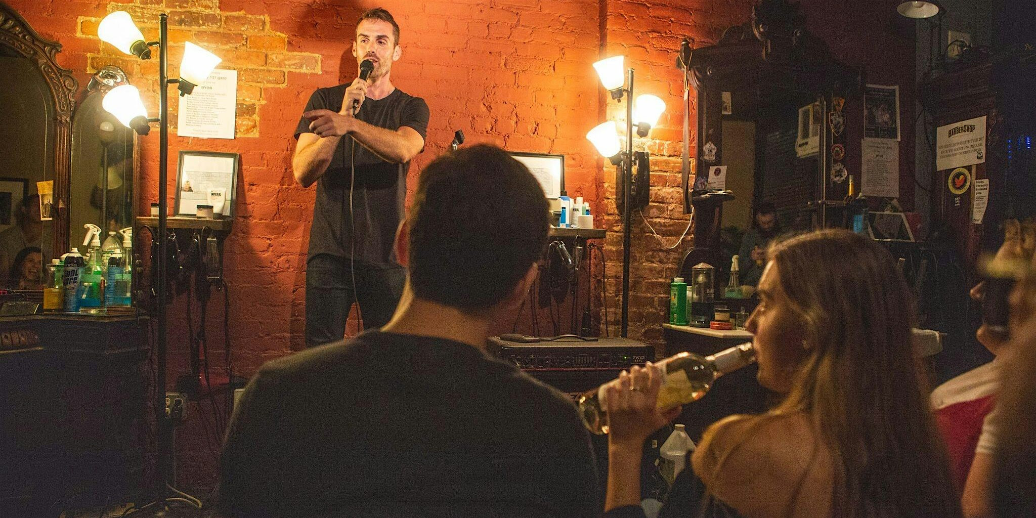 Crowd watching a comedy show inside Original Barbershop in the East Village
