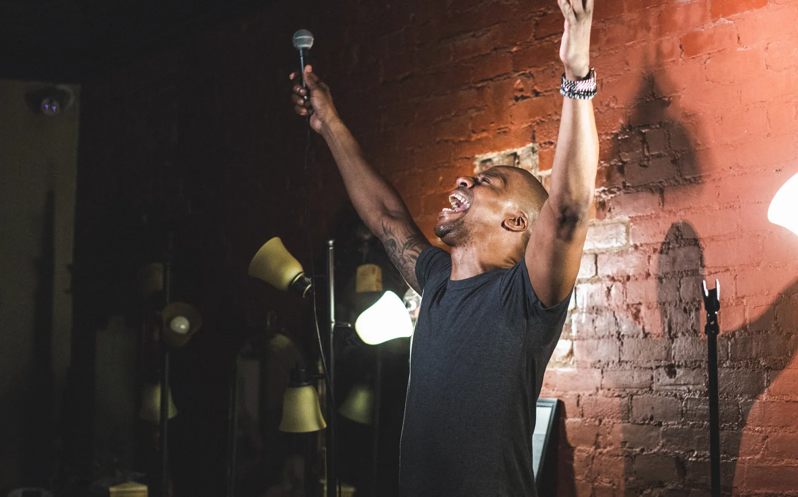 Stand up comedian performing at Live at the Barbershop NYC inside an East Village barbershop
