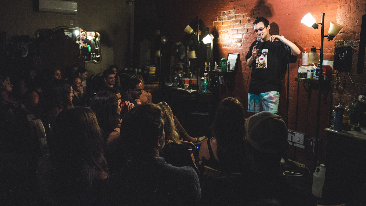 Comedian performing stand up at Live at the Barbershop in the East Village